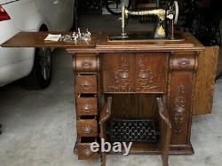 Antique Singer Treadle Sewing Machine In A Tiger Oak Closed Cabinet