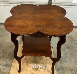 Antique quarter sawn tiger oak parlor table, cloverleaf design